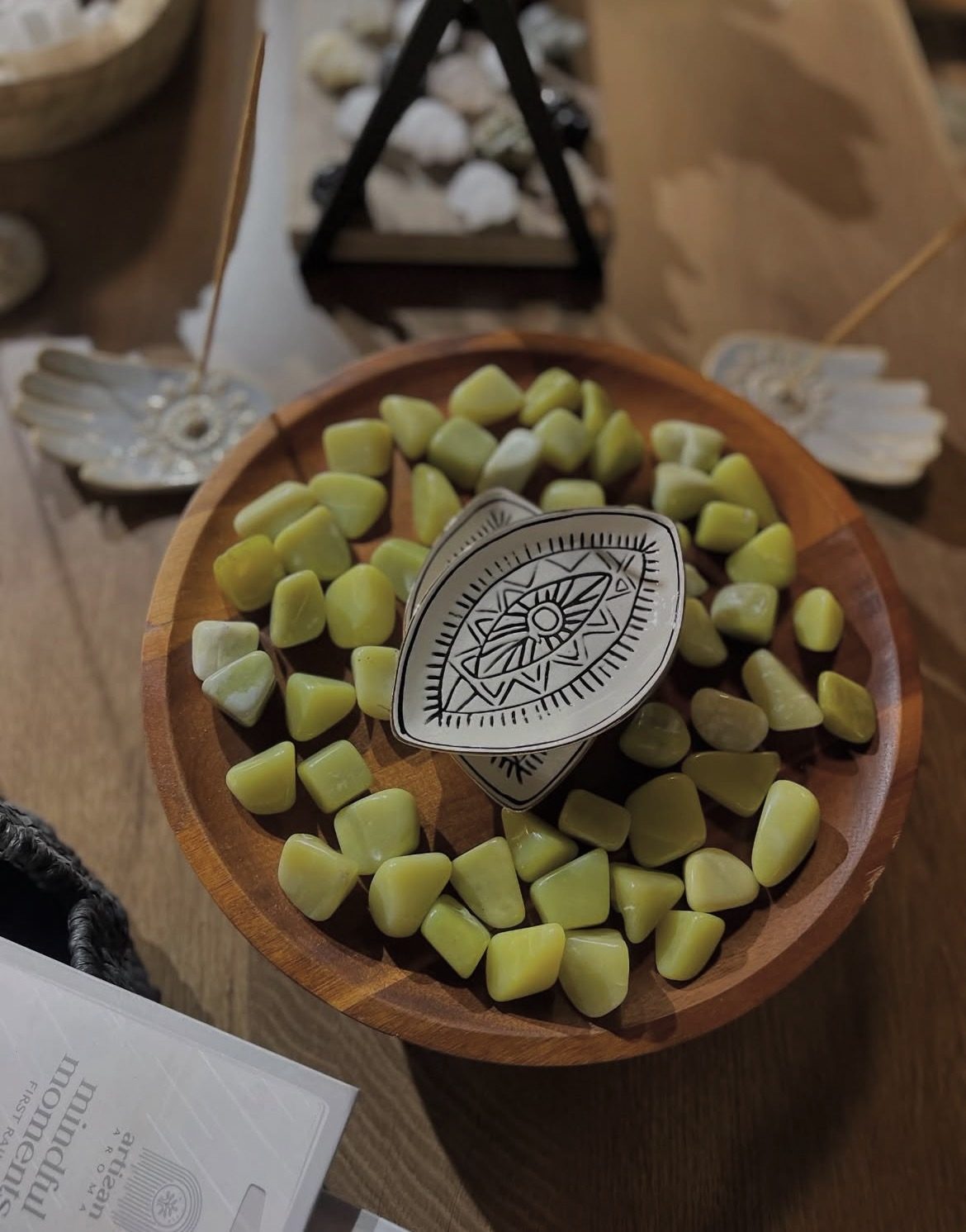 Polished natural stones in wooden bowl
